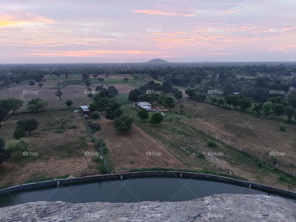 sunset in Rajasthan village.
in this picture collect rain water for farming with a beautiful sunset