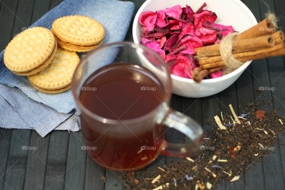 Tea tradition, tea, cup, mug, hot drink, cinnamon, cookies, napkin, jeans, denim napkin, fruit tea, flower tea, citrus, orange, lemon, rose petals, cookies, chocolate cookies, vanilla, vanilla sticks