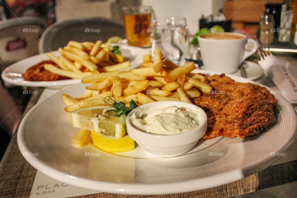 French fries and becka steak, tartar sauce, coffee, Beers, glass of water