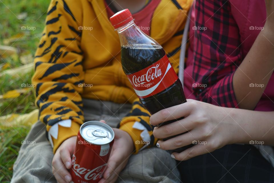 coca cola in the children hands outdoor