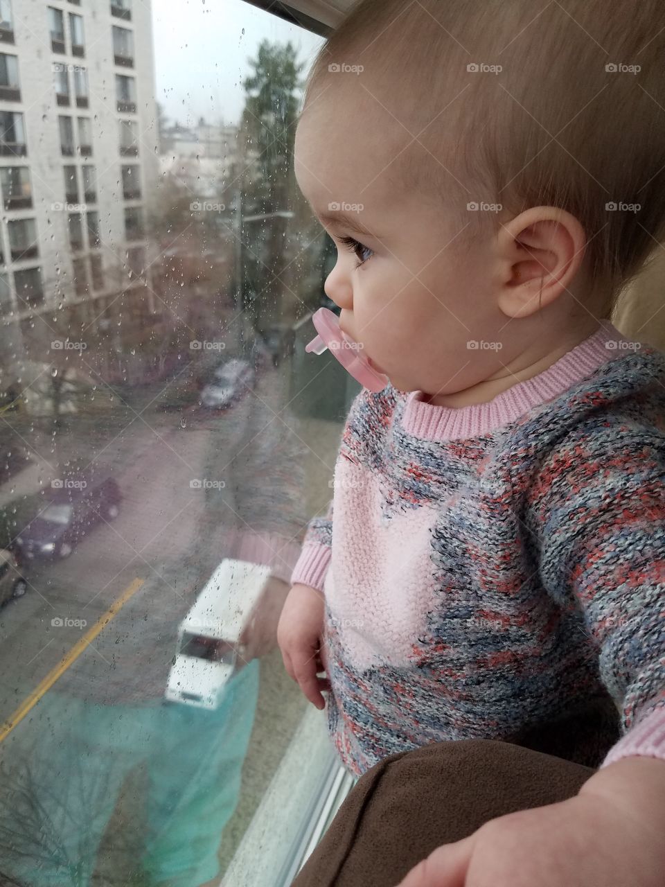 Baby boy standing near window