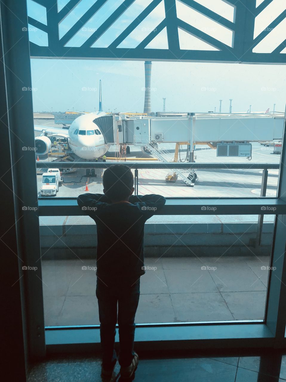 Little boy watching airplane 