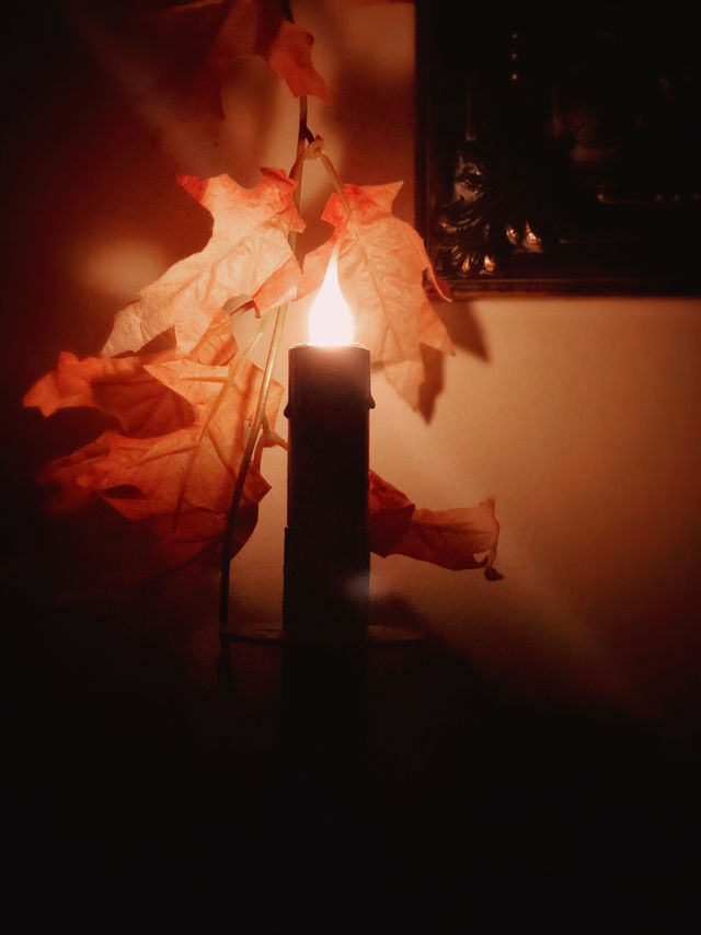 Candle glowing in a room