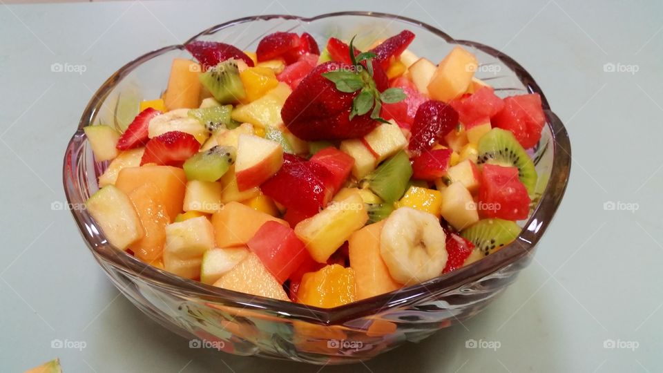 Fresh fruit salad. Freshly cut strawberries,  rockmelon, kiwifruit,  mango, banana, pineapple, and apple make a bowl fruity freshness.