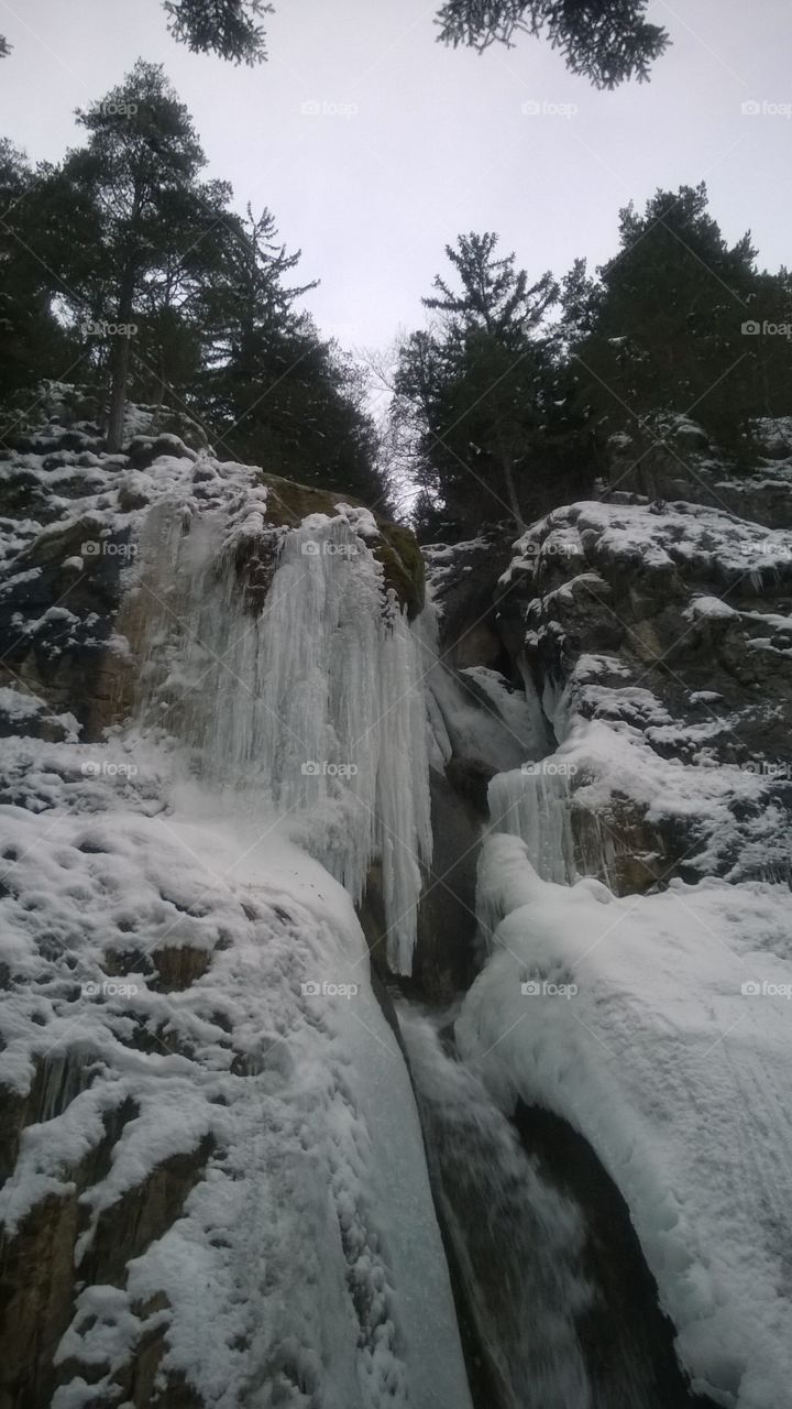 Low angle view of waterfall in winter
