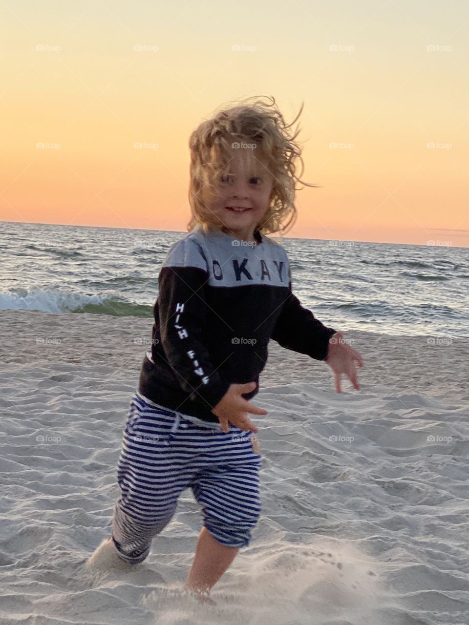 Boy playing on the beach 