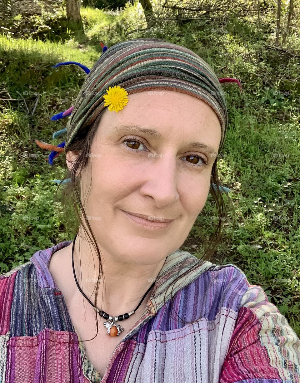 Self portrait in my hippy clothes with a dandelion tucked up my hairband 