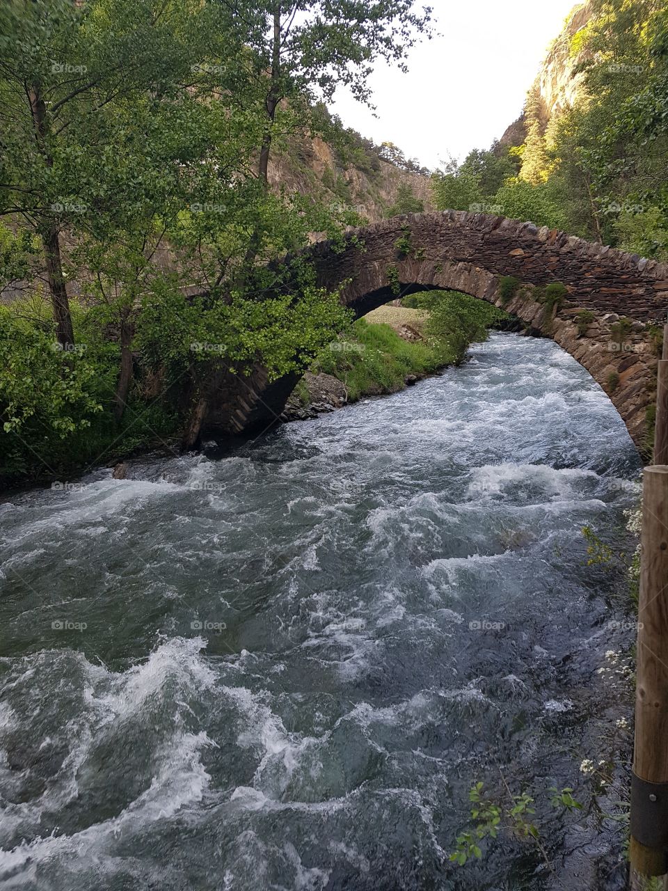 nice stone bridge over a wild river