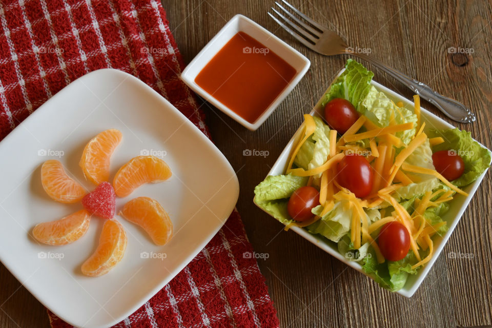 Crisp salad with a plate of mandarin oranges