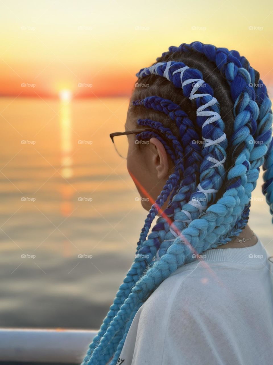 Girl with blue braids on a ship.