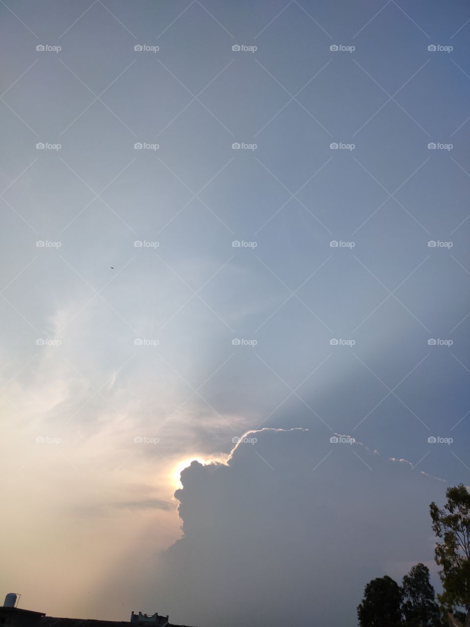 sun shining behind the clouds.