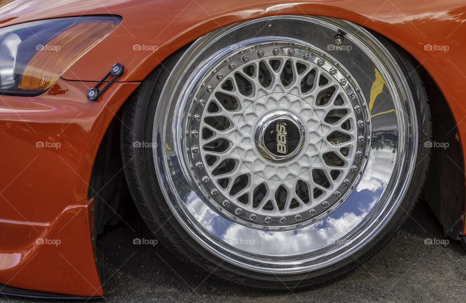 Closeup of wheel/tire And side/front of lowered car