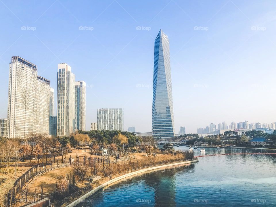 Autumn in Central Park of Incheon city. High buildings under a lake. South Korea