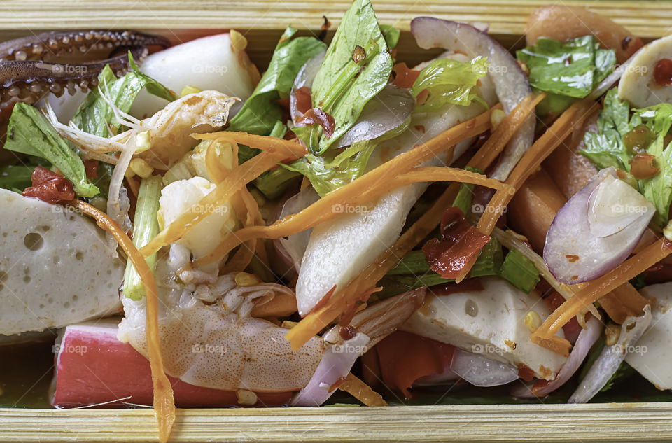 Spicy shrimp and squid with vegetables in bamboo.