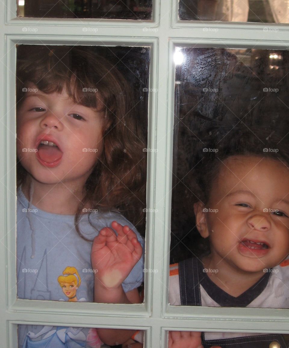 Sibling looking through window