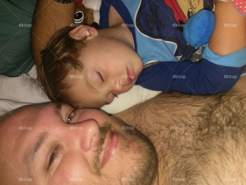 Baby boy sleeping with daddy