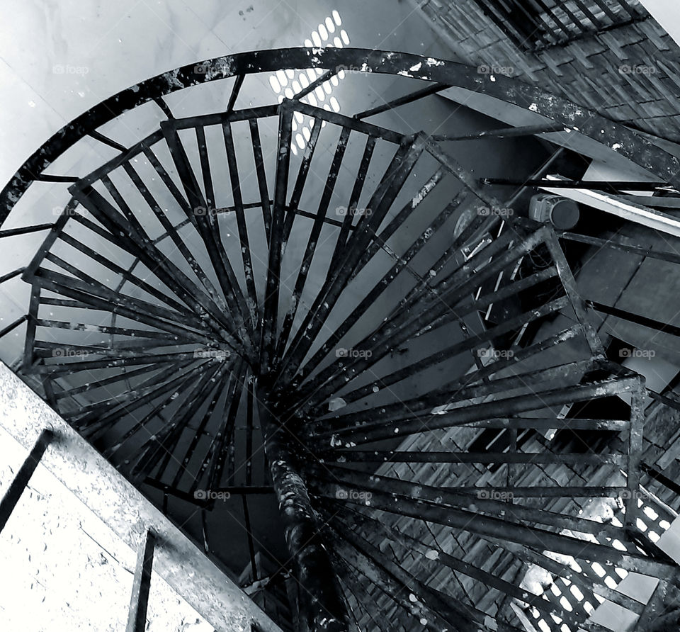 Vintage style spiral staircases black & white photo captured.