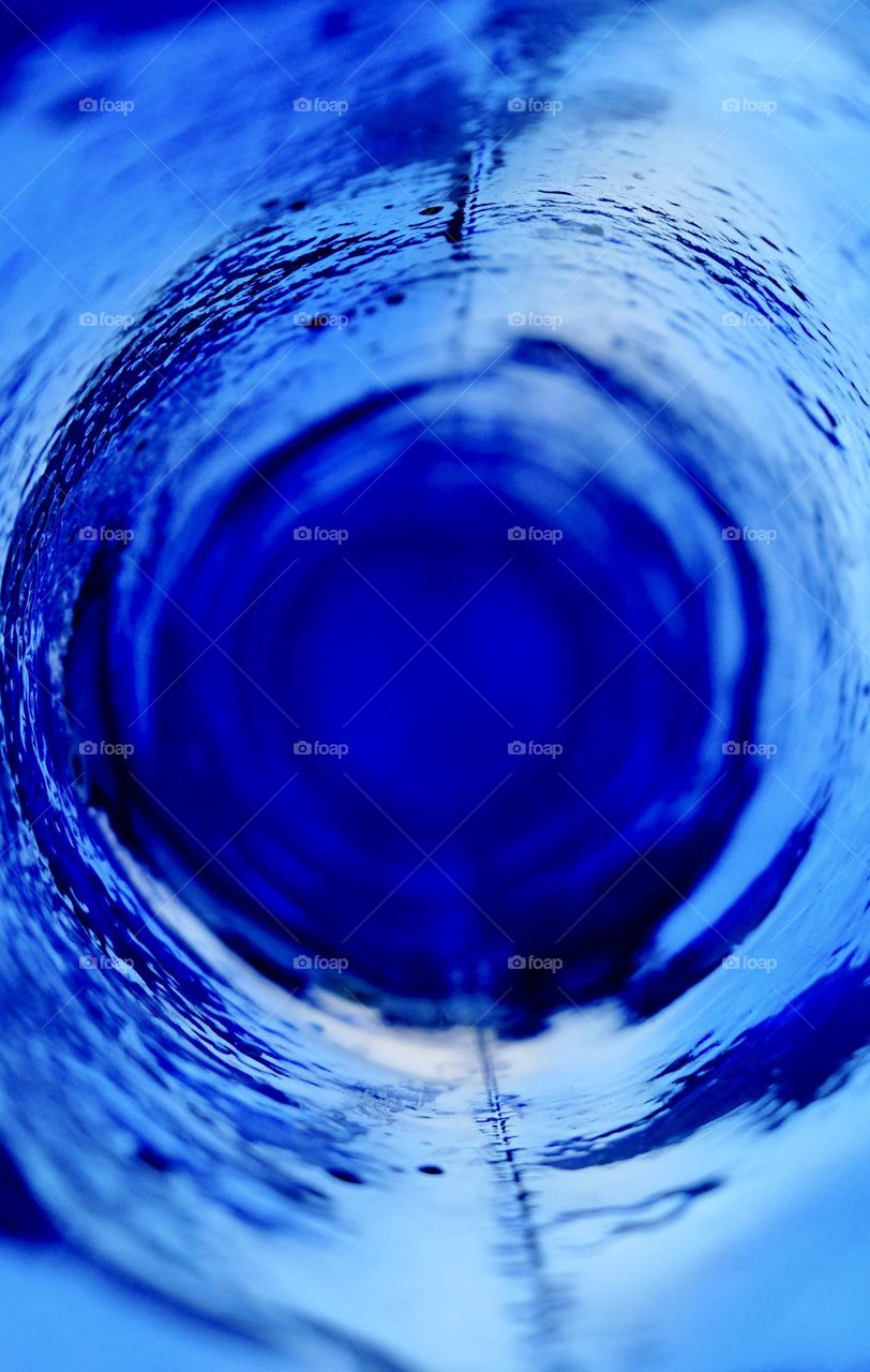 Inside a blue glass vase.