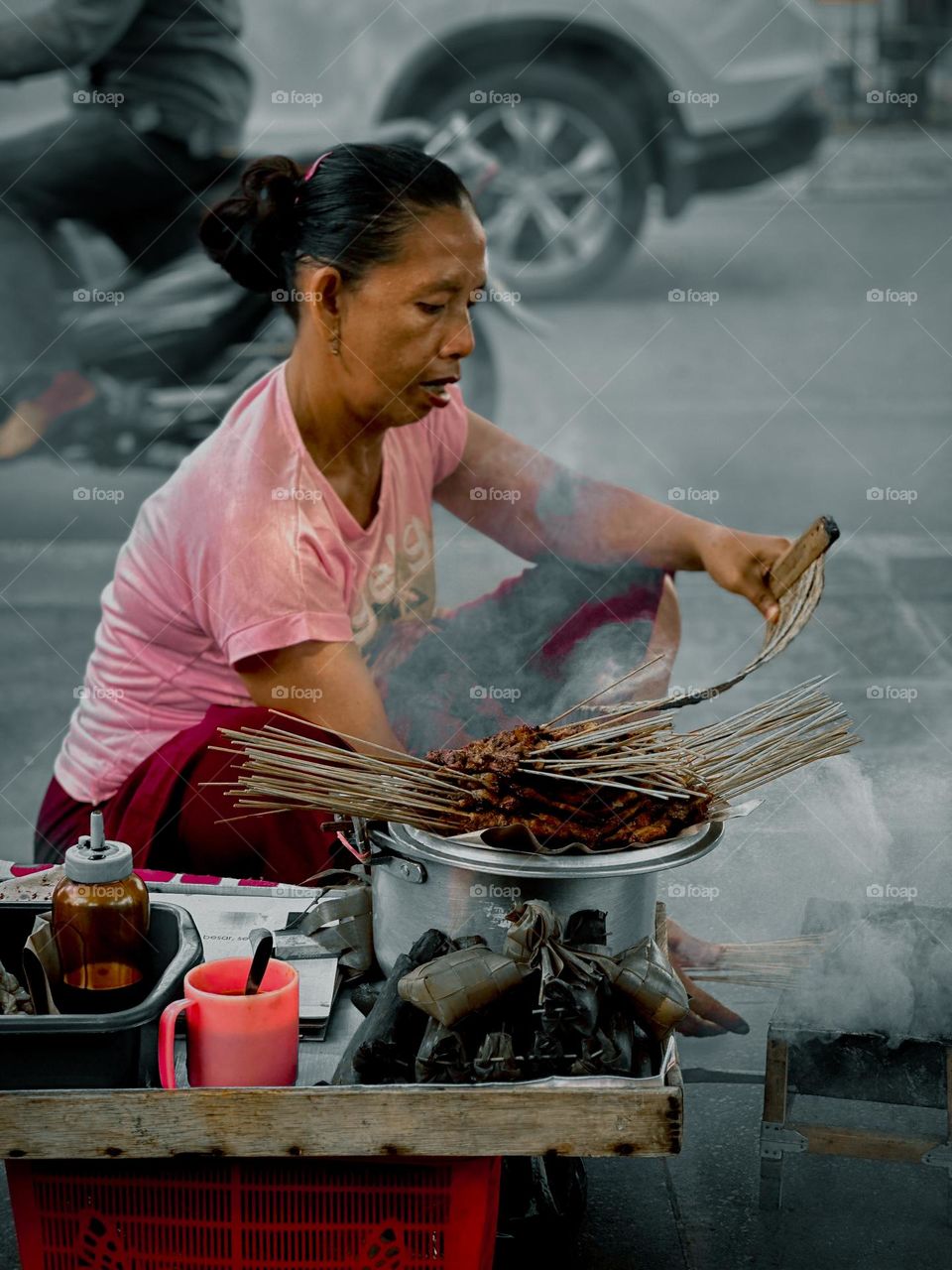 satay sellers who sell their wares by carrying them on their heads while moving from place to place