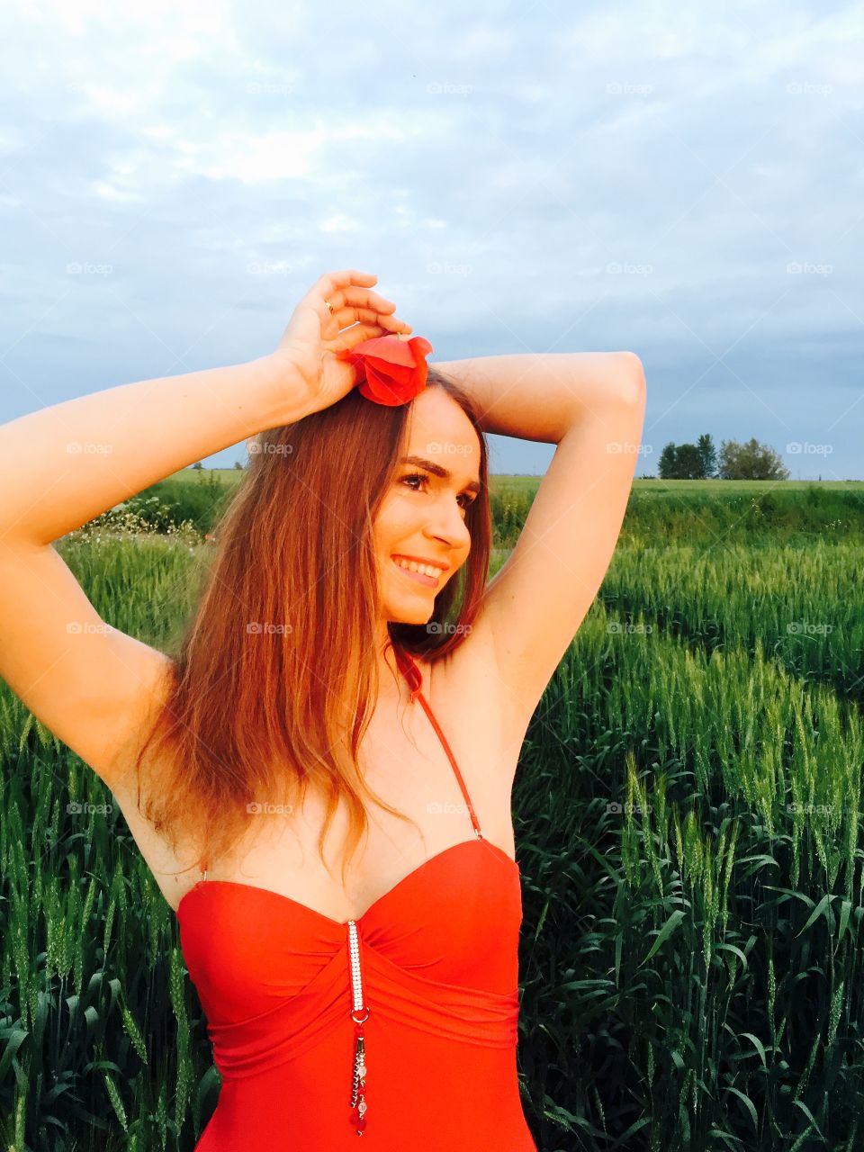 Happy young woman standing in wheat field