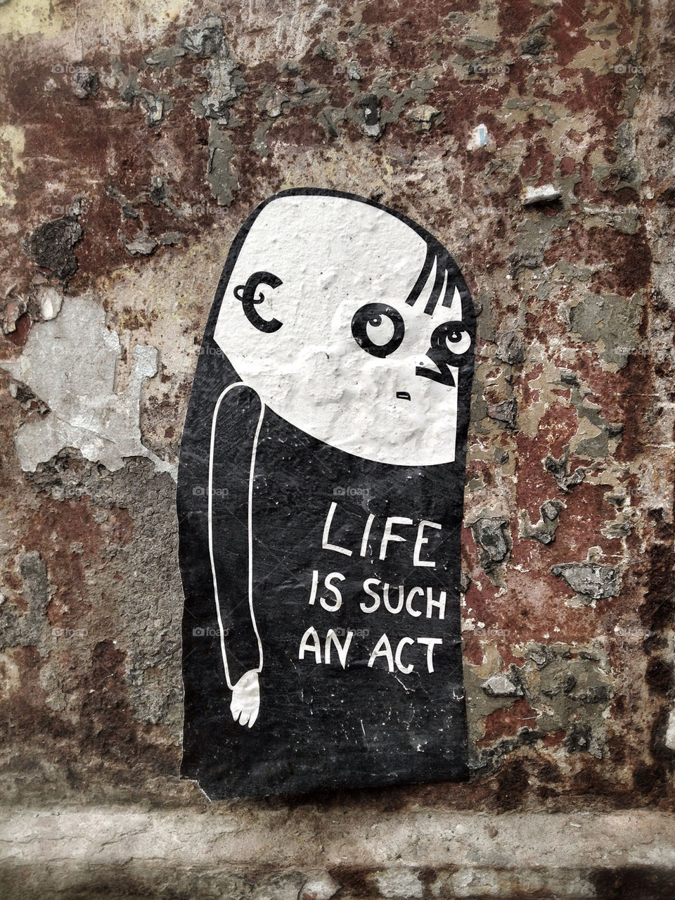 MAN ON GRAFFITI WALL WITH SLOGAN