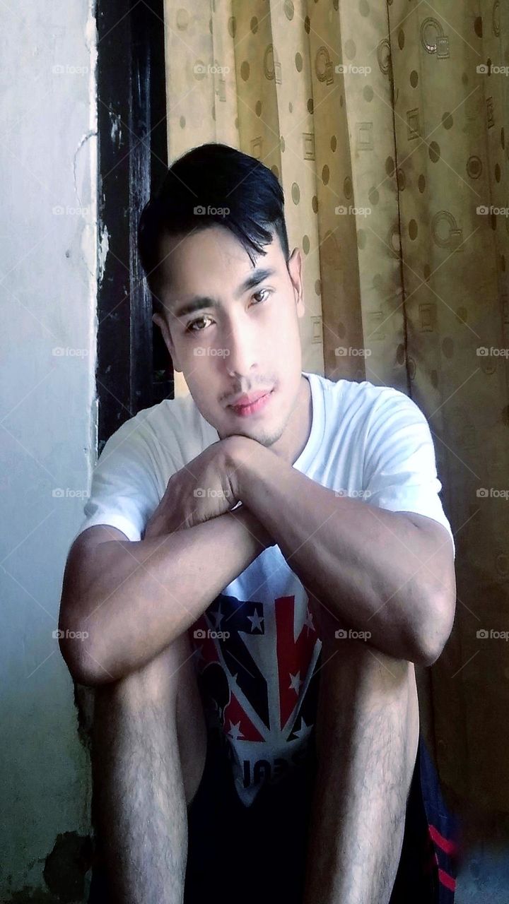 A young man sits while imagining something