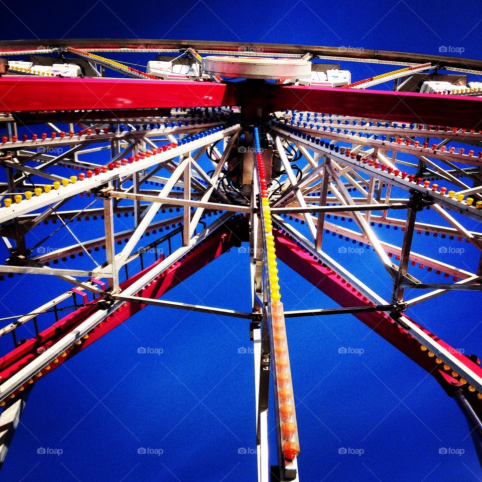 Ferris Wheel . Looking up at the ferris  wheel at a local fair 