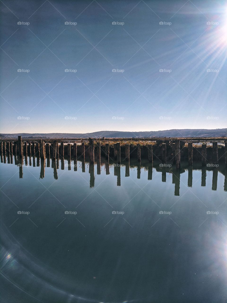 Beautiful reflection of the bridge at the adriatic seaside in autumn.