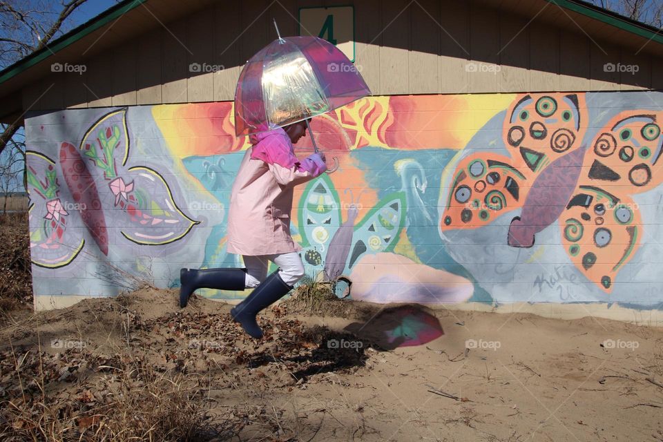 Colorful mural with woman holding umbrella 