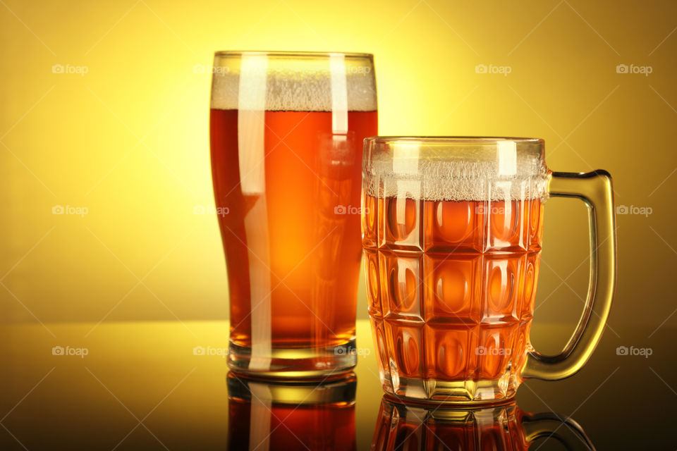 Beer glass and mug with reflection