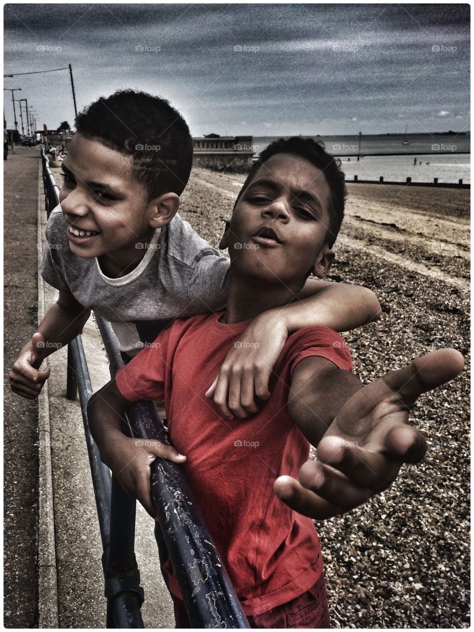 Two expressive boys at the seaside in Southend