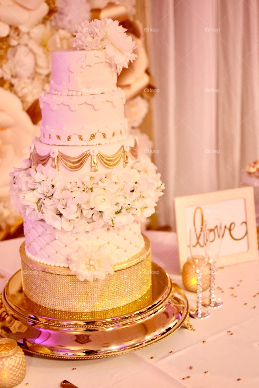 Beautiful white and gold three tier wedding cake