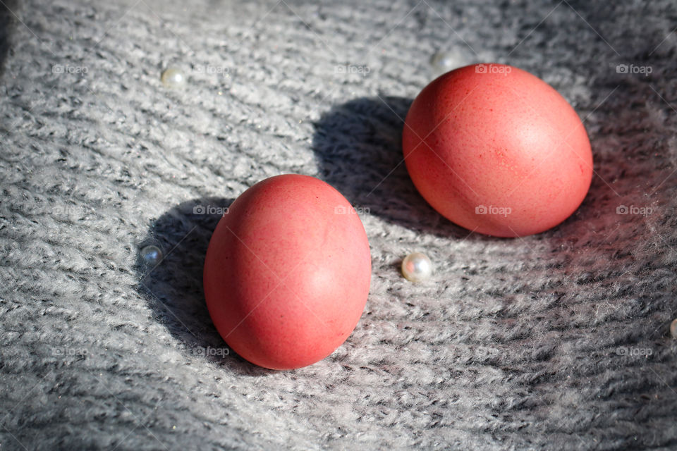 Pink Easter eggs on a gray background
