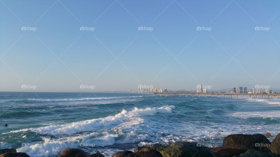 Surfer with Gold Coast in Distance