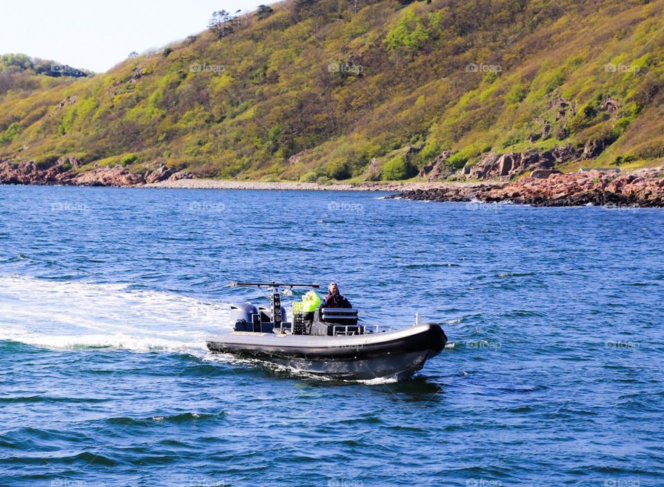 Rubberboat . A fast going rubberboat in blue ocean