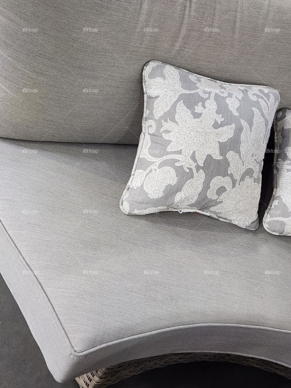 contemporary couch with gray and white floral pillow