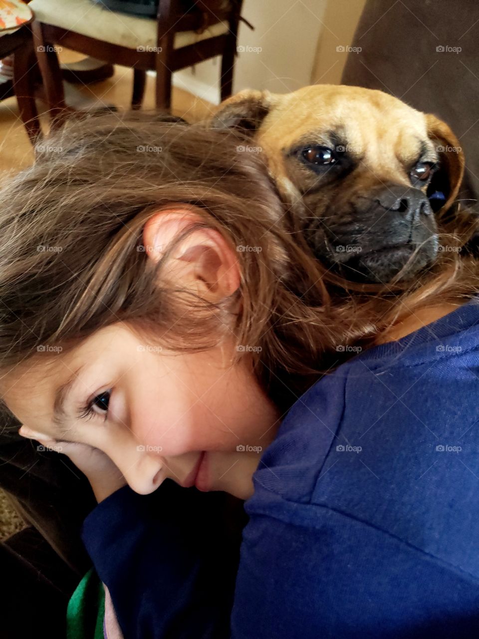 girl snuggling with puppy