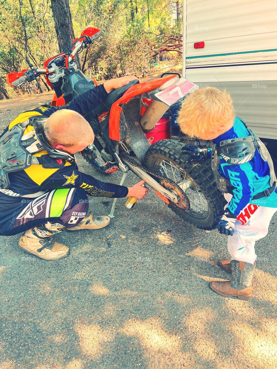 Father and son getting ready to go ride in the forest 