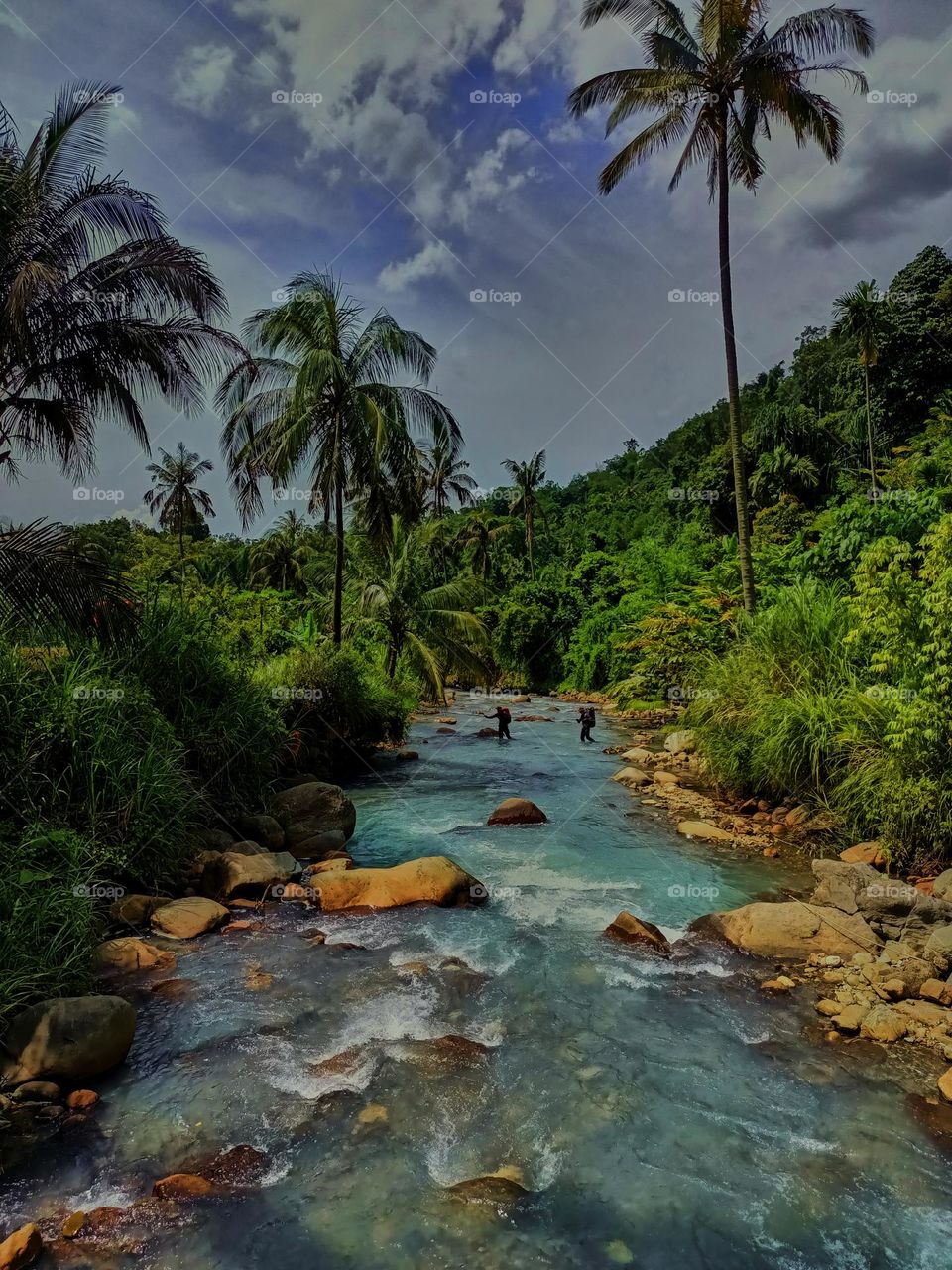 Panoramic landscape of bright blue river of dua rasa river and tropical rain forest