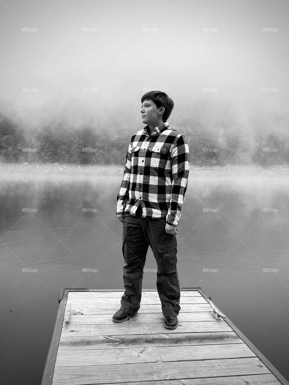 A young man enjoying a beautifully peaceful morning on the dock