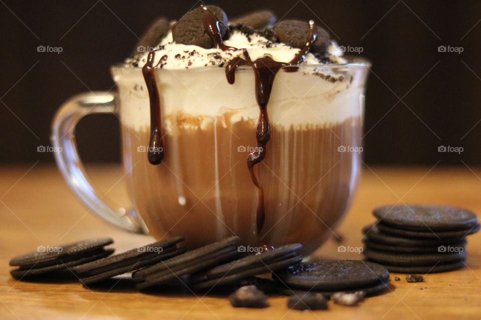 Homemade hot chocolate with fresh whip cream and sandwich cookies.