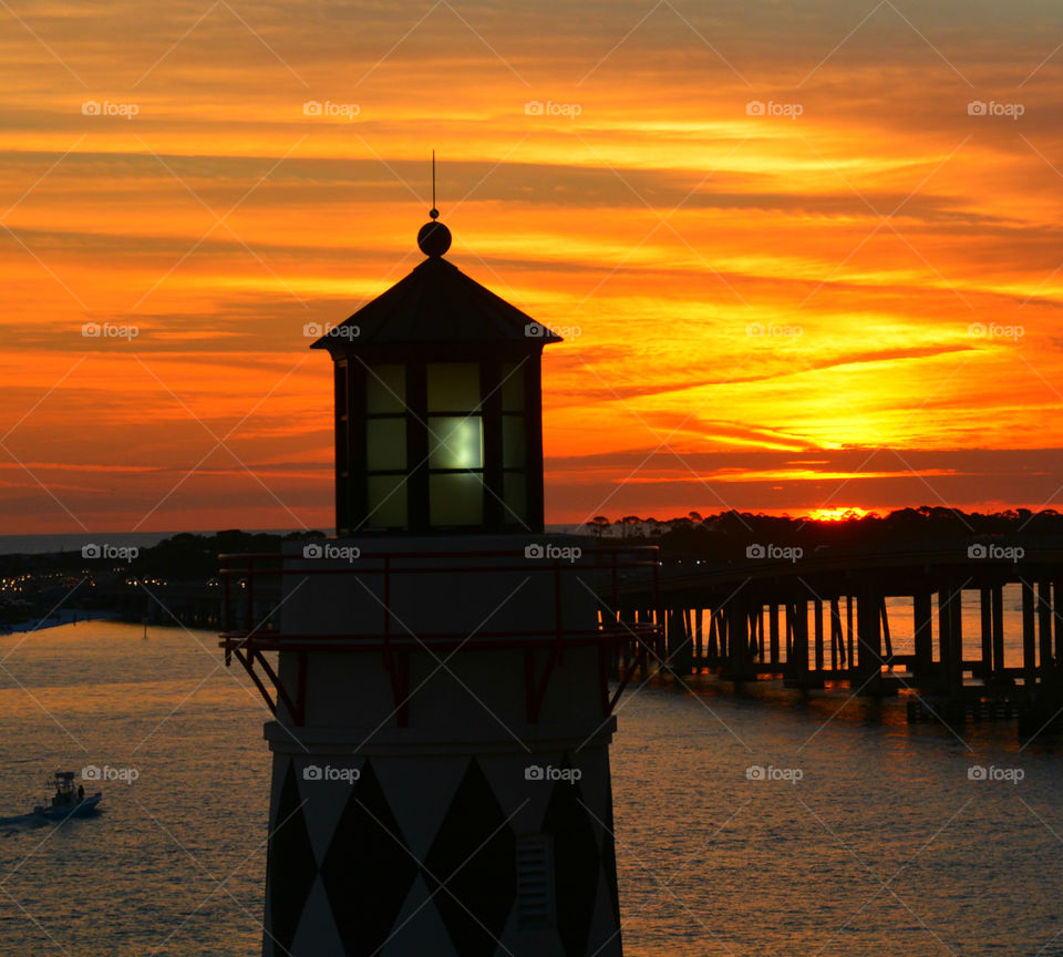 Silhouette of lighthouse at sea