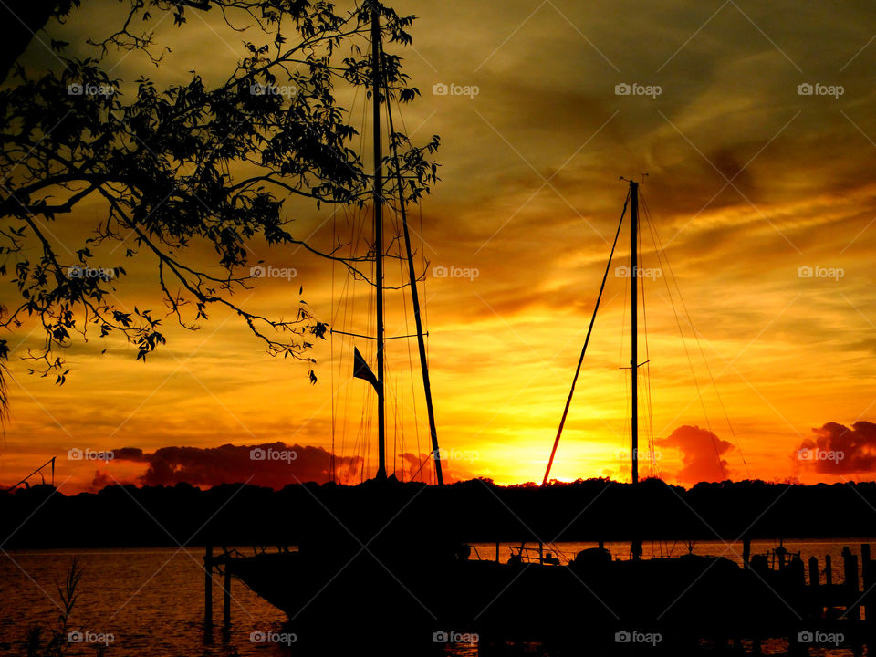 Silhouette of boat in sea during sunset