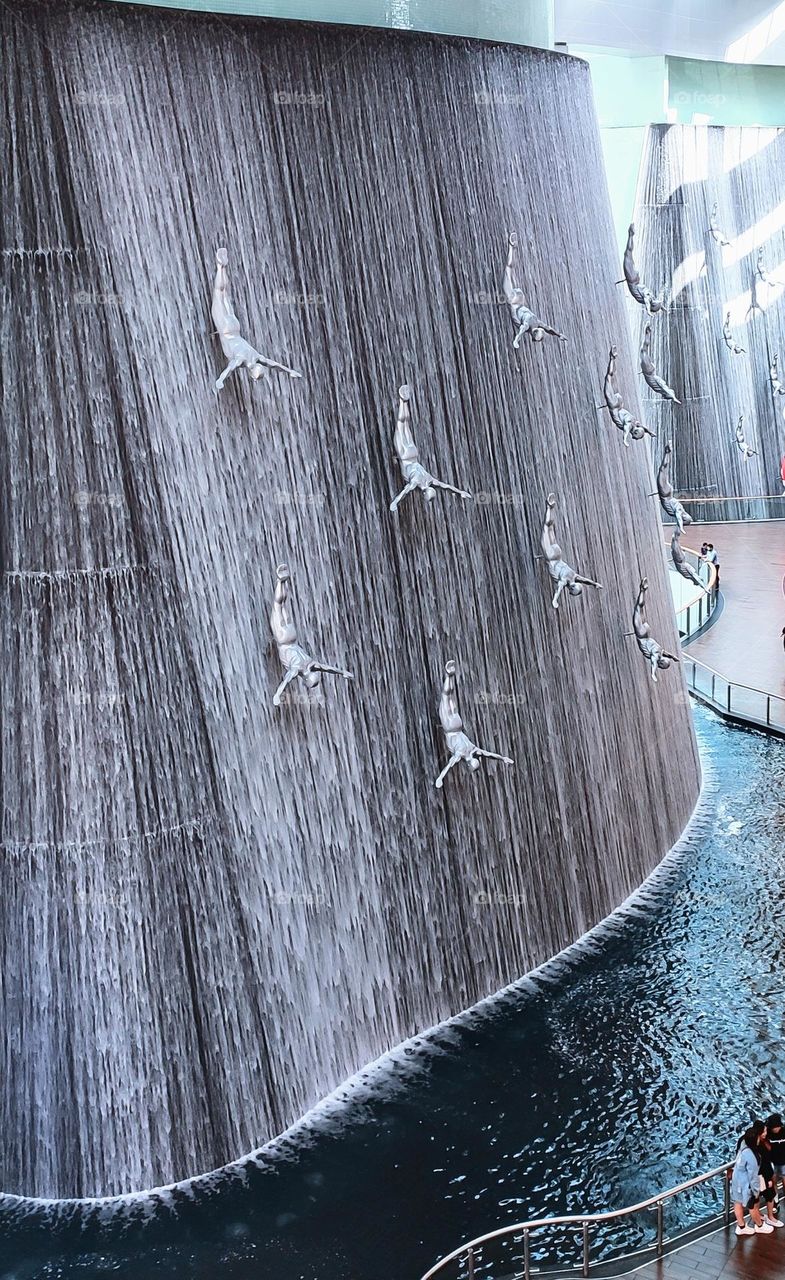 Time in Motion with water flowing downwards at Human Watergall in Dubai Mall. Timeless loop.