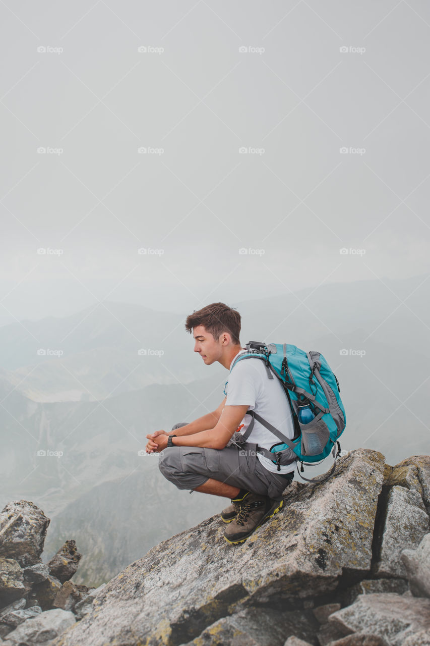 Sad boy sitting on hill