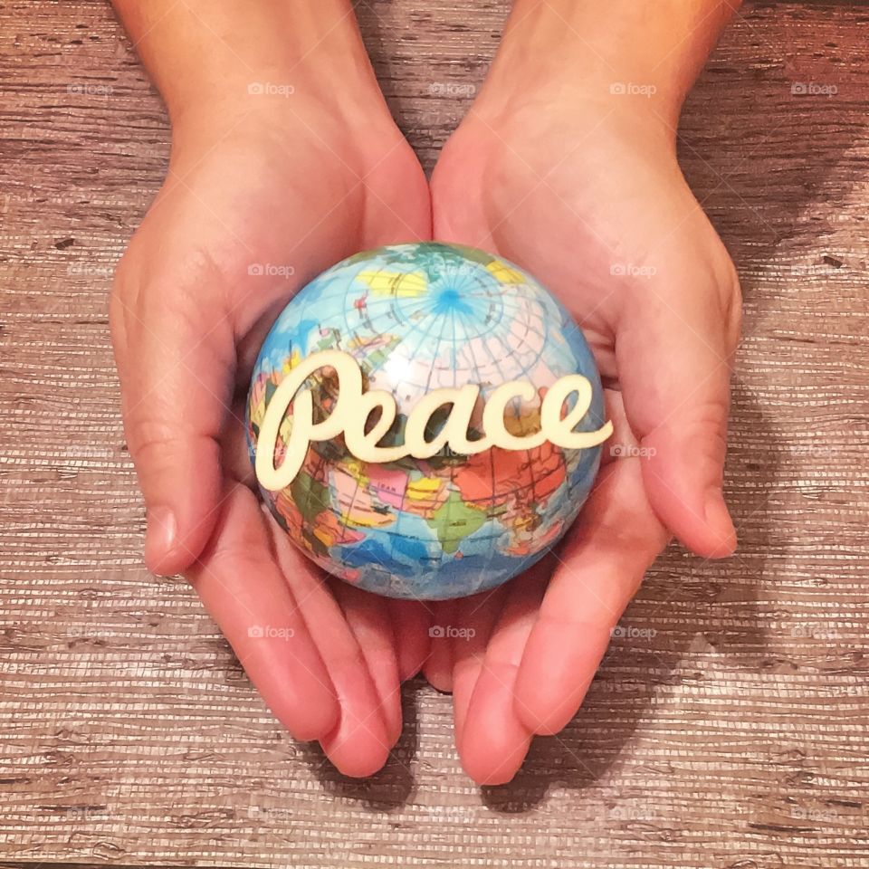 Hands Holding Peace on Earth