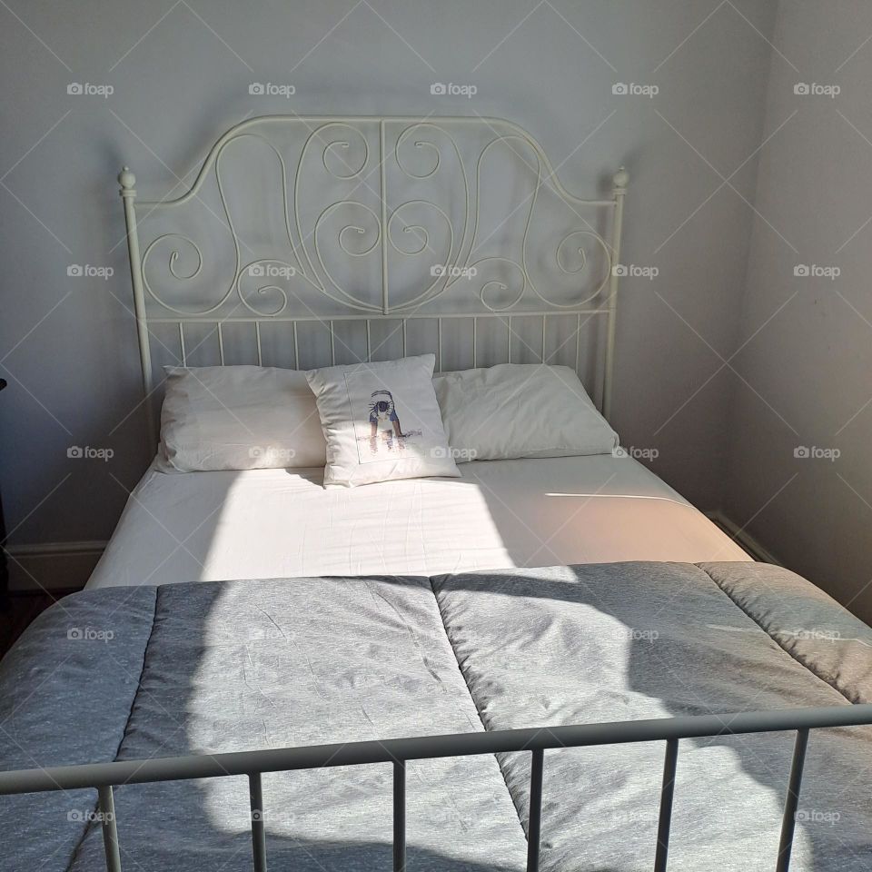 simple sunny morning made bed. daylight pure