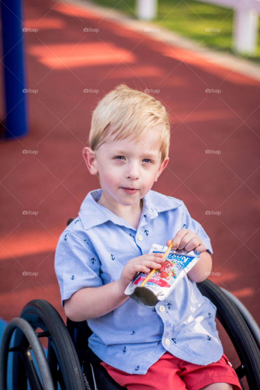 Young Boy in Wheelchair Holding a Capri Sun 3