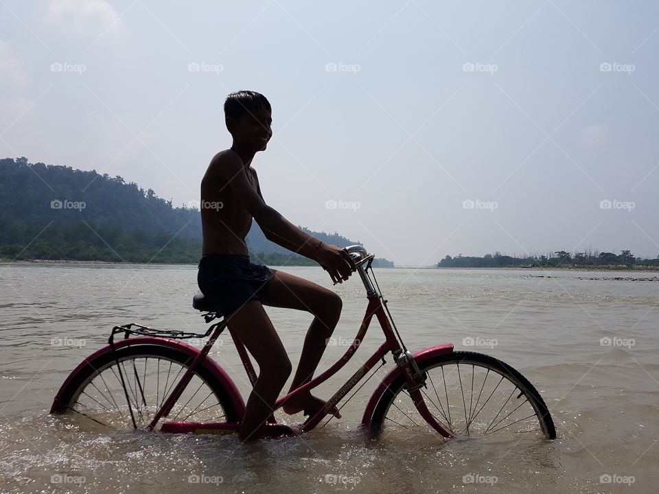 riding cycle on river ganges