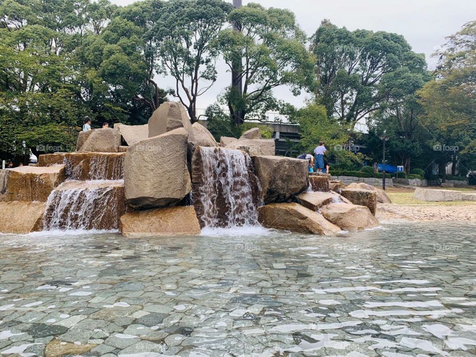 artificial waterfall with trees beautiful view